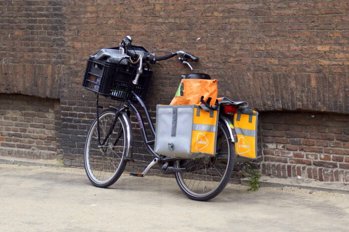 postnl-bike-parked-against-brick-wall