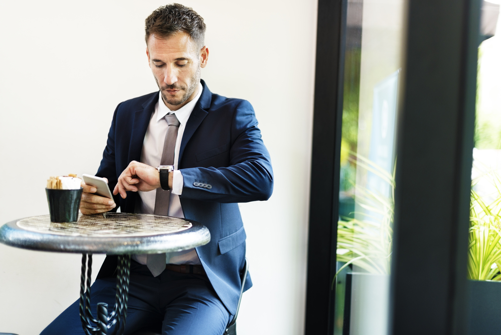 punctual business man looking at watch