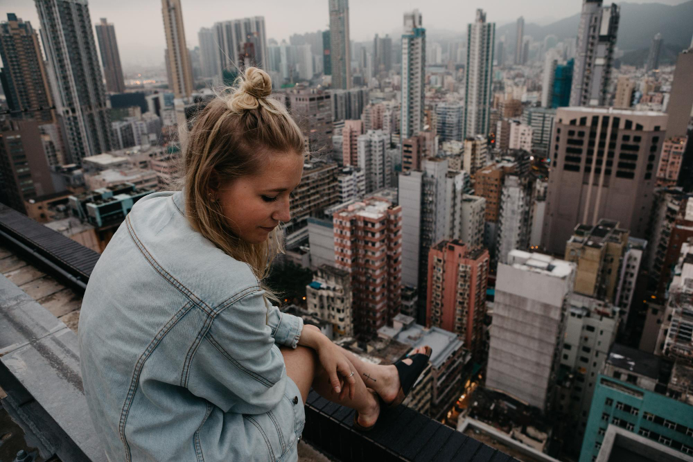 photo-of-woman-overlooking-city-scape-while-working-abroad