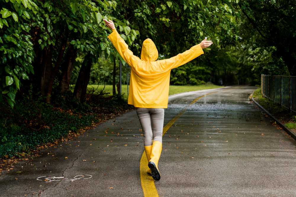 back-view-of-woman-in-raincoat-in-rainy-park