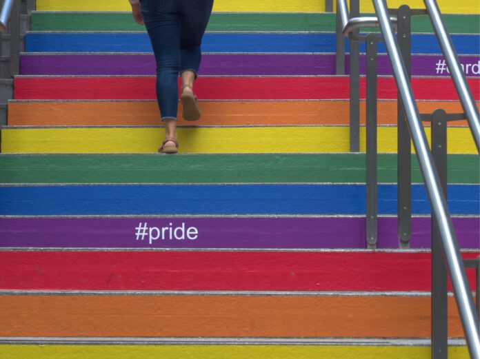 woman-stairs-pride-rainbow-colours