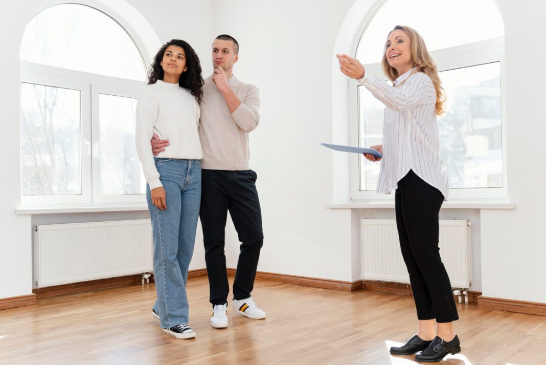 photo-of-dutch-real-estate-agent-showing-a-couple-a-house-in-the-netherlands-to-buy-with-big-windows-and-white-walls