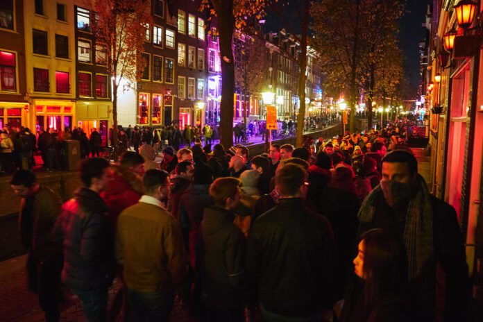 Red-light-district-in-amsterdam-at-night-stay-away-campaign