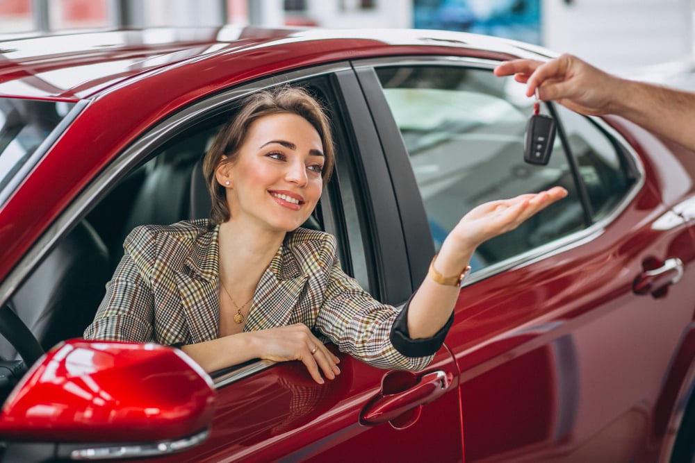 photo-woman-sitting-red-car-receiving-keys
