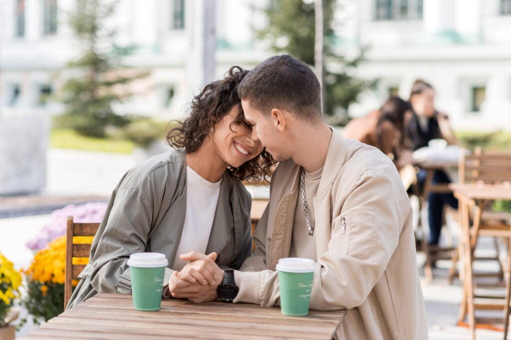 Romantic-couple-Dutch-man-and-international-woman-sitting-outside-a-cafe-together