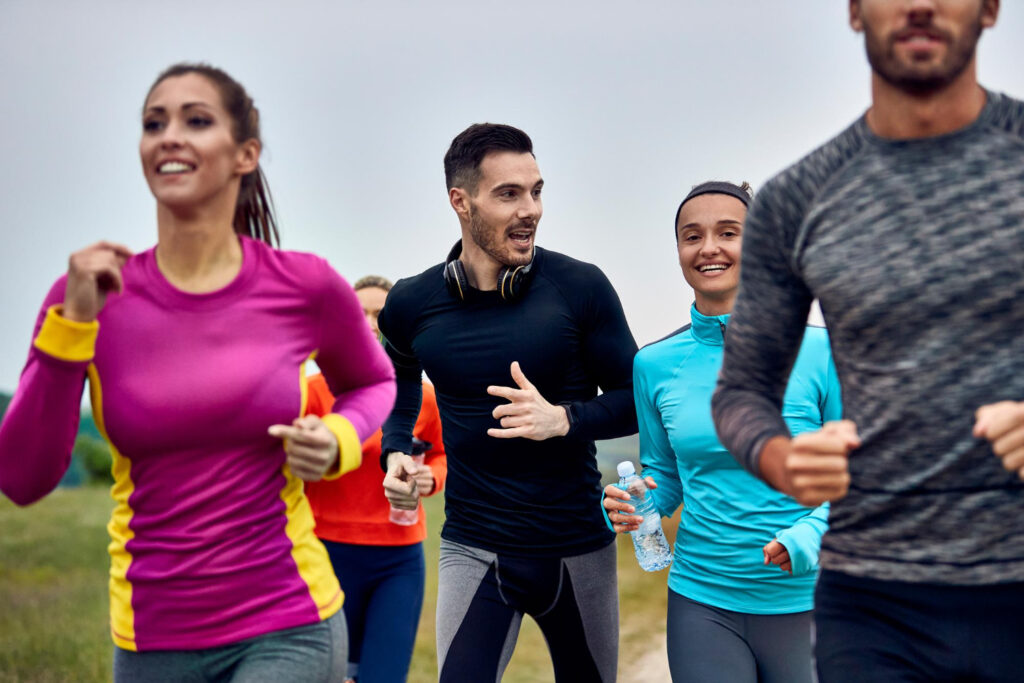 photo-of-smiling-running-club-out-exercising-together