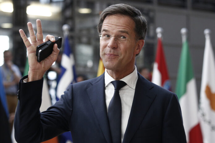prime-minister-netherlands-mark-rutte-waving-with-flags-in-background