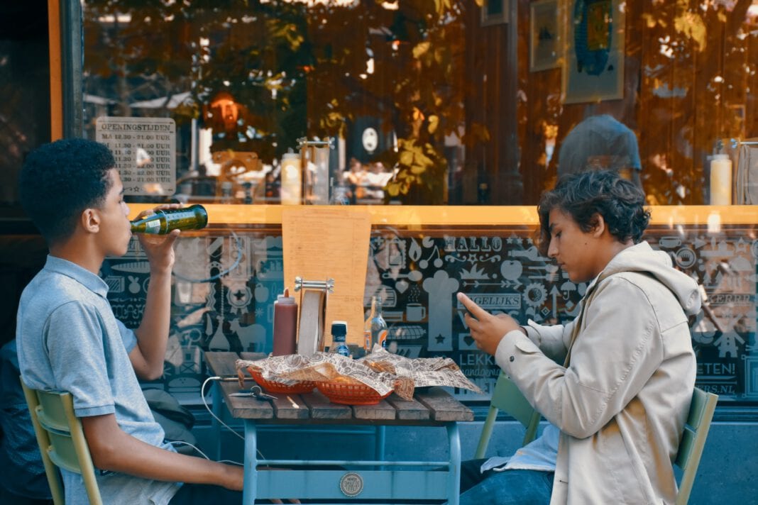 Dutch-boys-drinking-and-eating-on-a-terrace