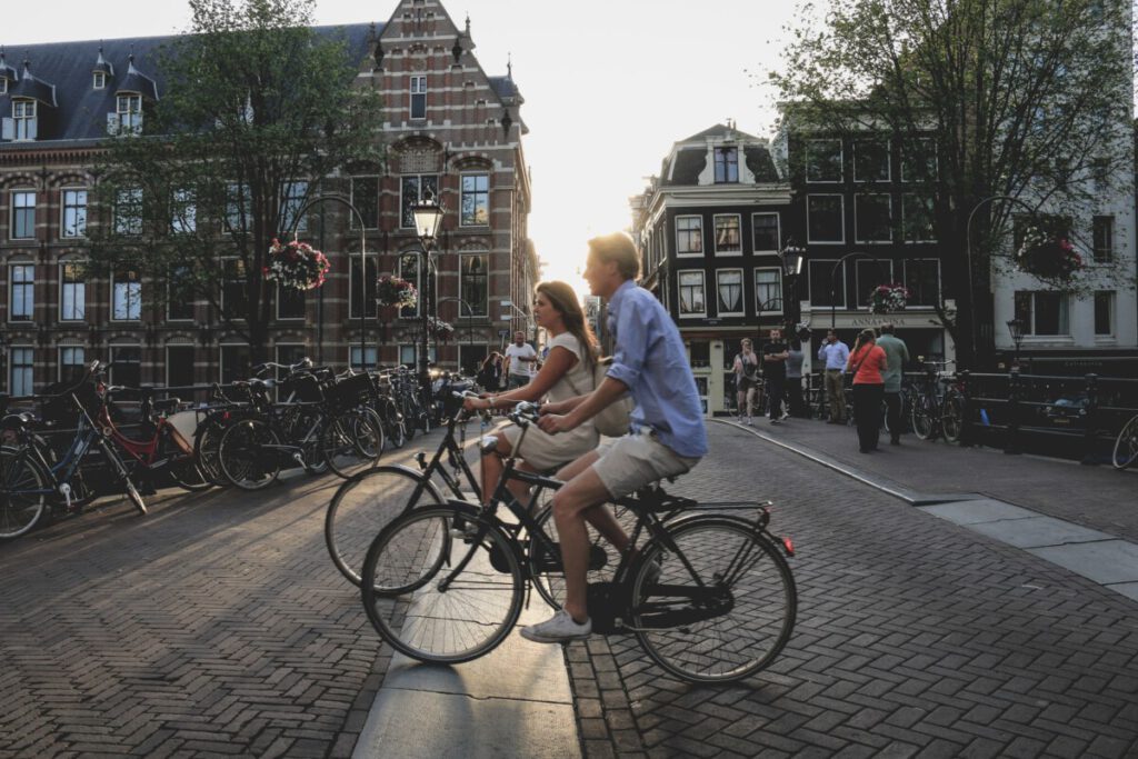 photo-of-student-couple-cycling-through-amsterdam