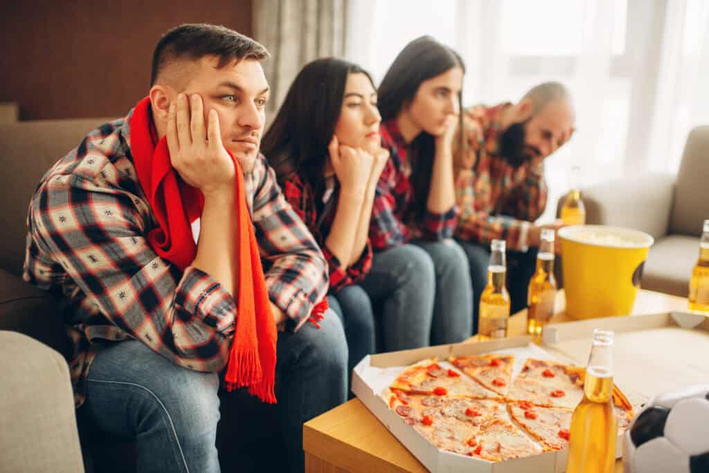 sad-friends-watching-tv-at-a-boring-dutch-house-party