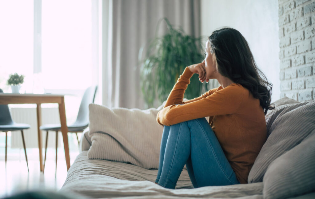 photo-of-sad-woman-depression-sitting-on-her-couch-couch-isolating