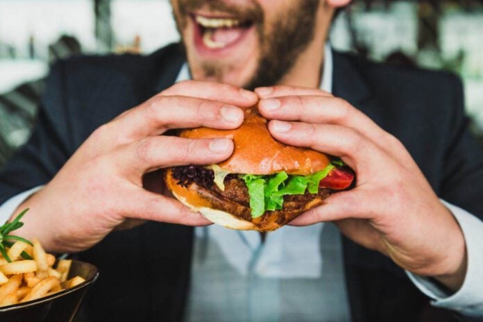 Photo-of-man-eating-veggie-burger