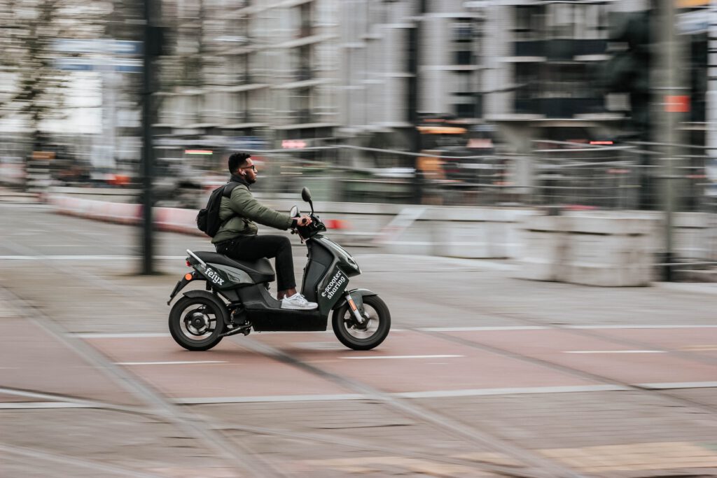 photo-of-man-riding-shared-scooter-around-amsterdam