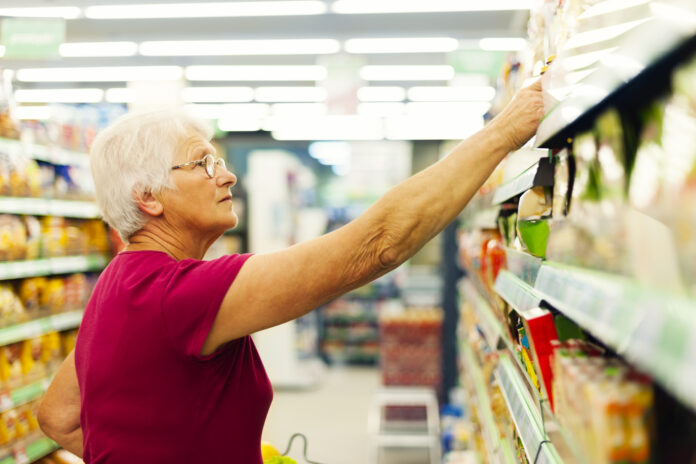 senior-citizen-reaching-for-groceries-in-a-supermarket