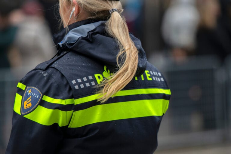 photo-of-female-dutch-police-officer-on-street-in-rain