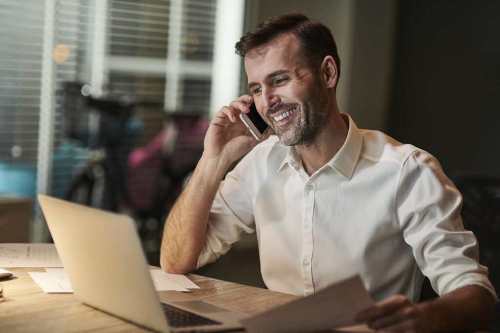 smiling-man-talking-to-utility-provider-on-mobile-phone-in-the-netherlands