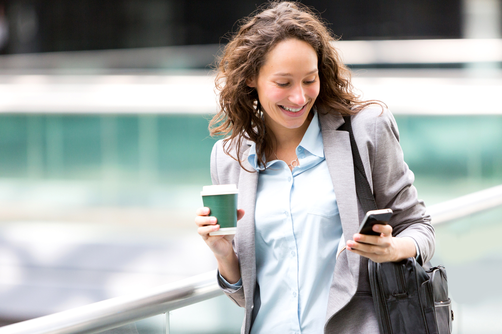 smiling-woman-using-facebook-during-her-morning-commute