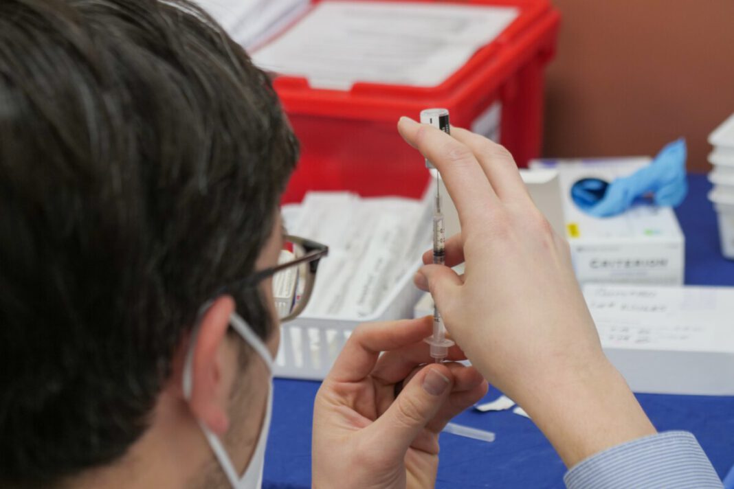 man-holding-the-AstraZeneca-vaccine-in-the-Netherlands