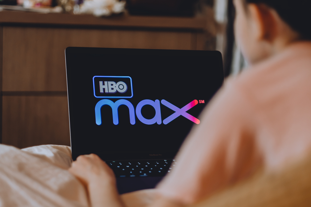 photo-person-watching-hbo-max-on-laptop-in-bed