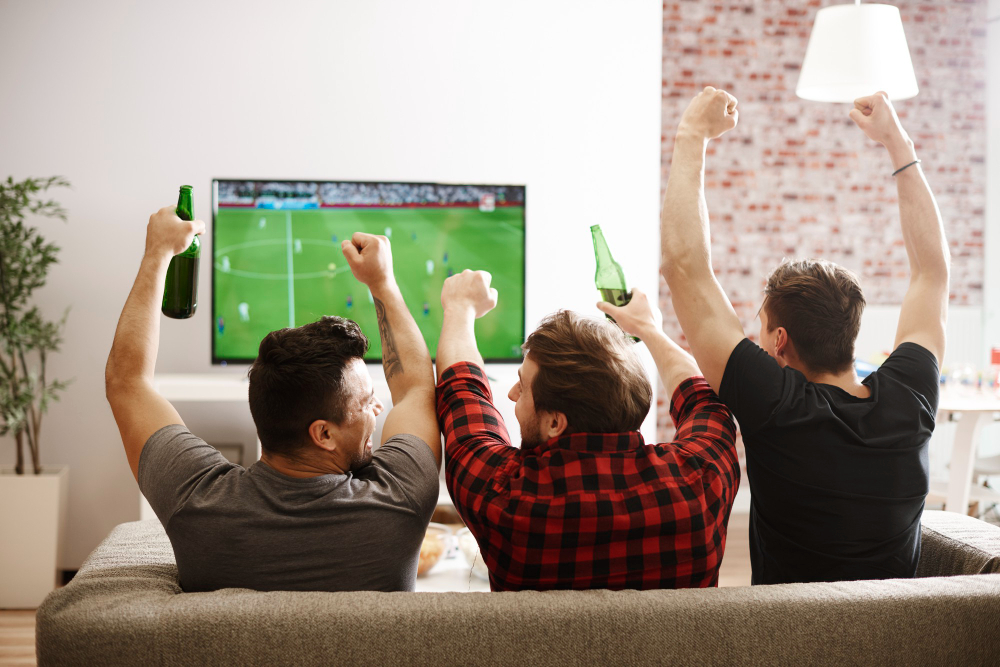 three-young-men-watching-football-on-tv-channels-in-the-netherlands