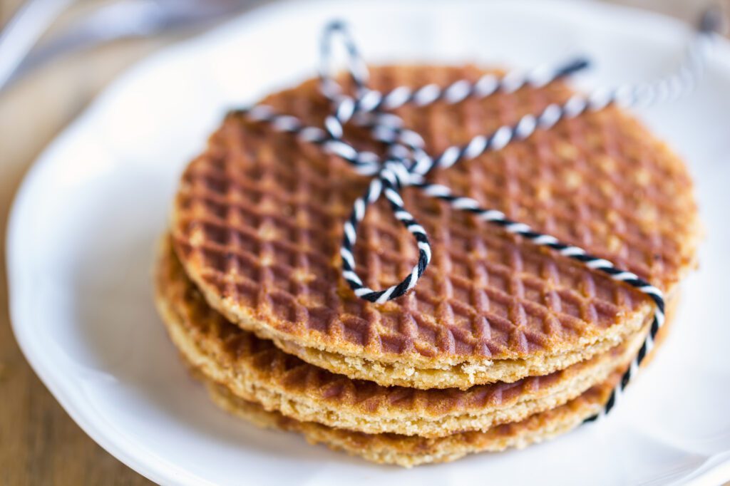 photo-of-stroopwafels-stacked-on-plate-tied-with-blue-and-white-ribbon