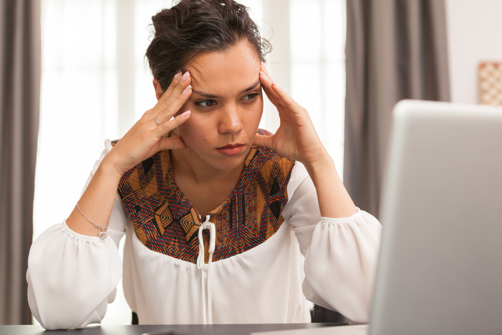 Student thinking in front of her laptop