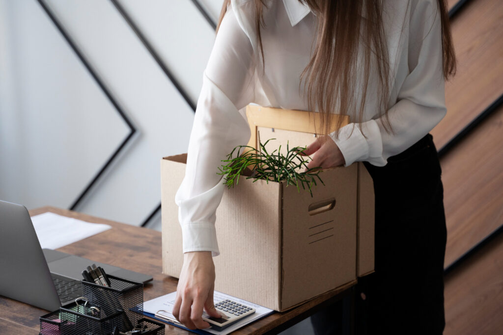 photo-of-woman-packing-things-in-office-after-being-instantly-dismissed-netherlands