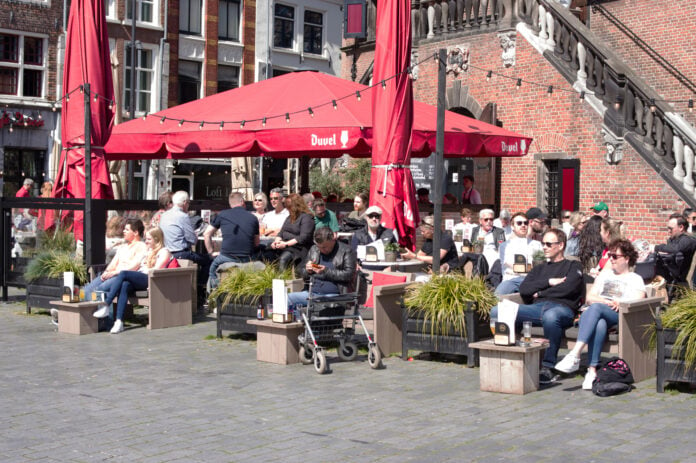 photo-of-people-sat-outside-at-a-sunny-terrace-bar