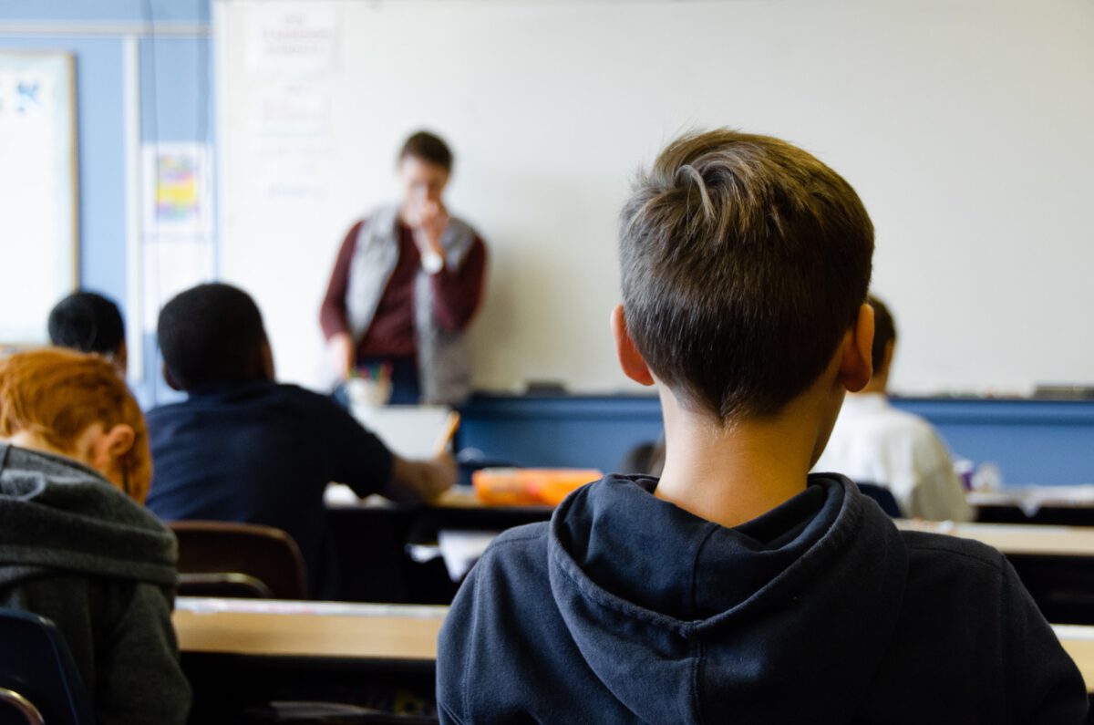 young-informal-carer-sitting-in-school-classroom-in-the-Netheralnds