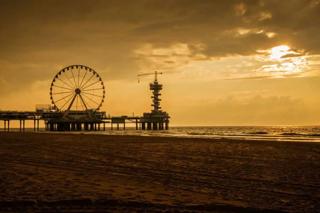 photo-of-the-hague-pier-during-orange-yellow-sunset-beach-sand