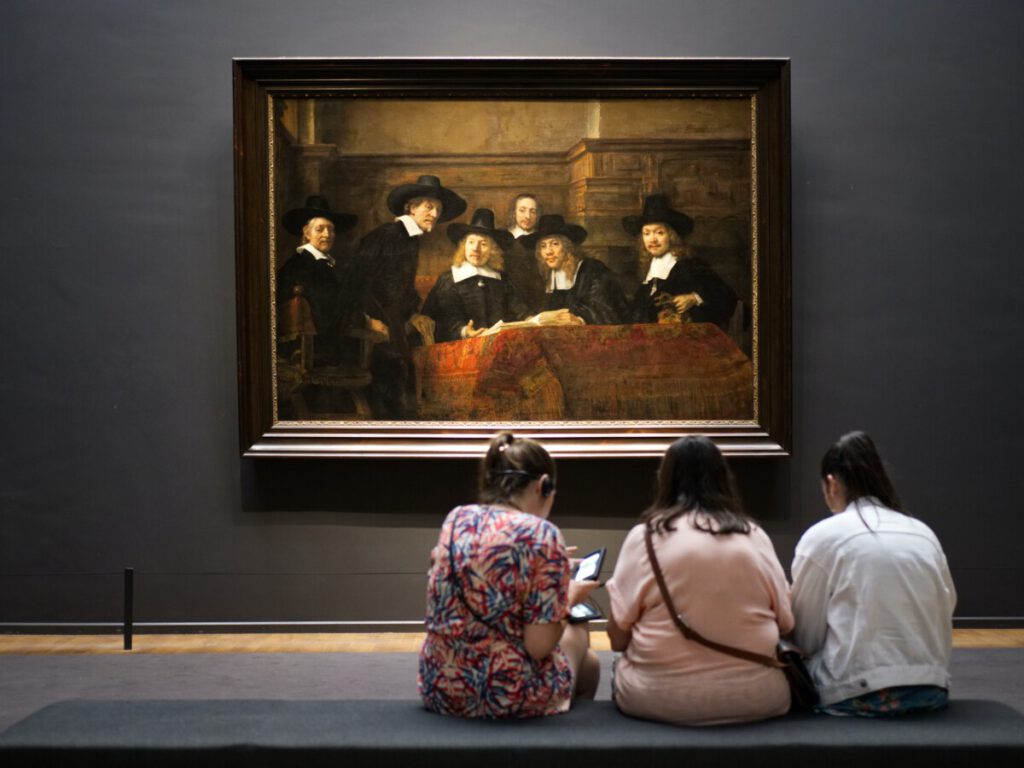 Three girls watching a Rembrandt in the Rijksmuseum, Amsterdam.