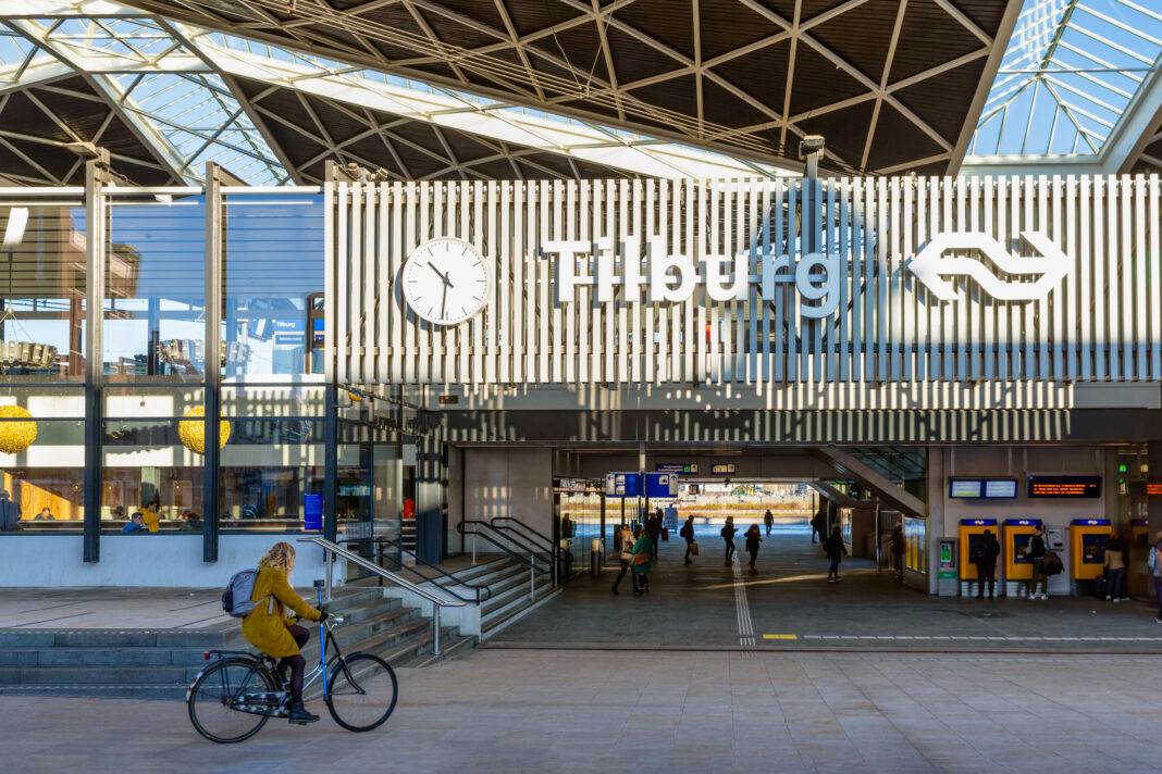 Railway-station-in--Tilburg-with-passing-cyclist-and-pedestrians