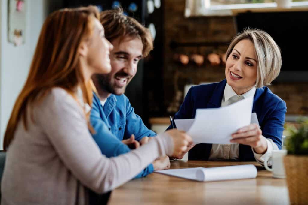 photo-of-Dutch-mortgage-expert-giving-tips-to-expat-couple-at-table-about-how-to-get-a-mortgage-in-the-netherlands