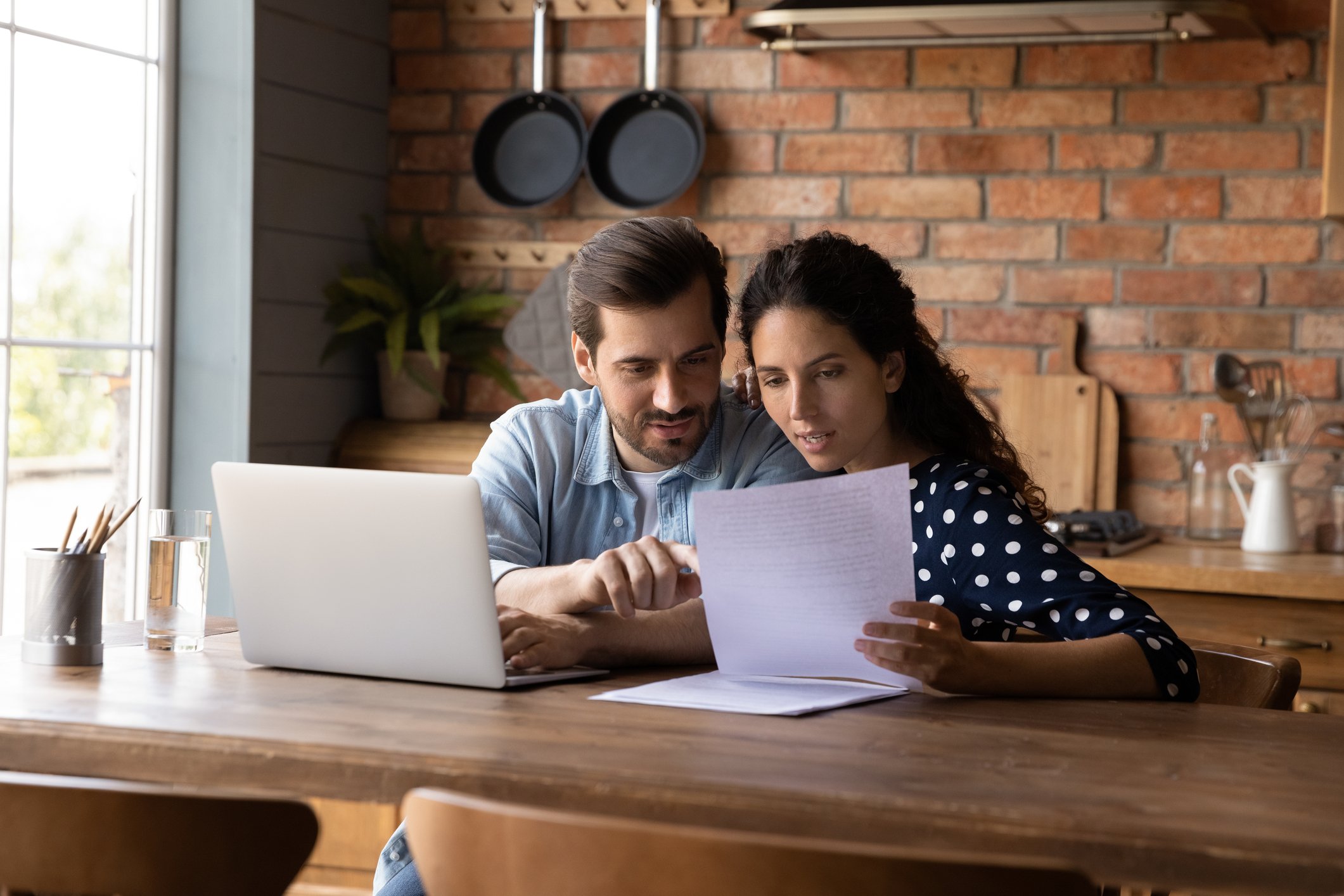 photo-of-man-and-woman-looking-at-papers-discussing-house-sale-netherlands