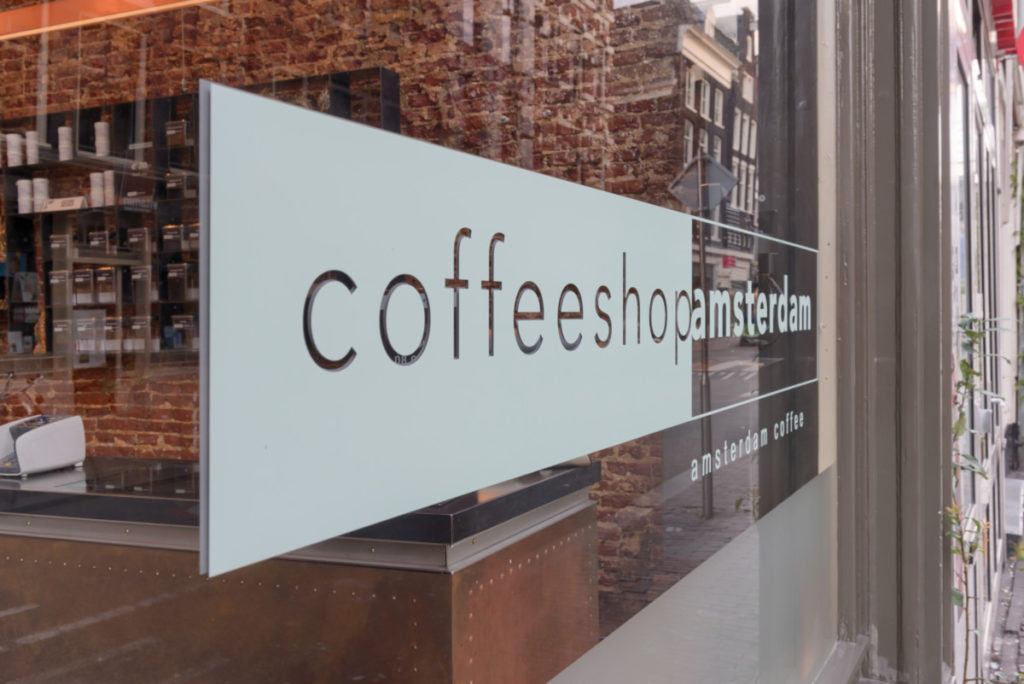 photo-of-white-logo-on-window-of-coffeeshop-amsterdam