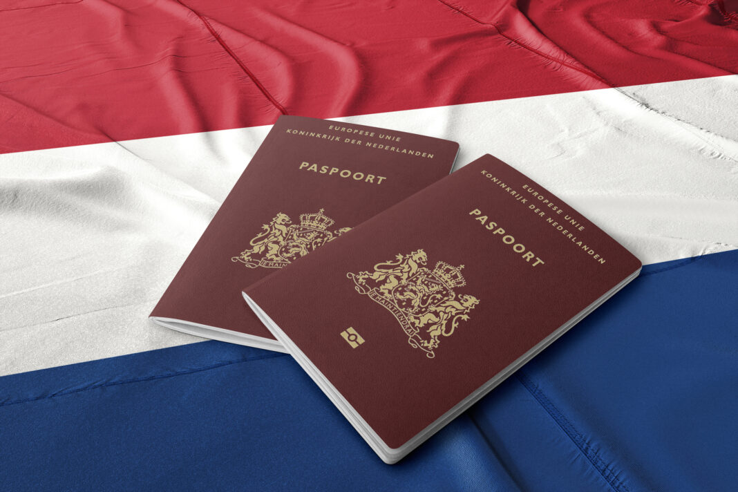 two-dutch-passports-sitting-on-dutch-flag