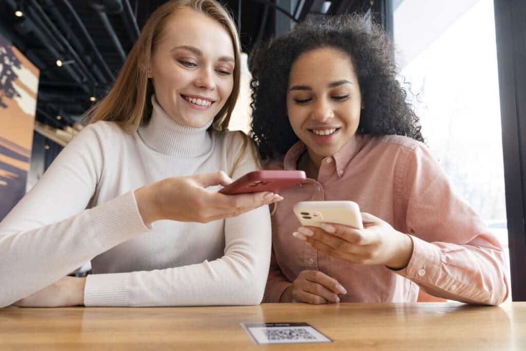 two-friends-ordering-food-in-a-restaurant-in-the-netherlands-using-dutch-bank-accounts