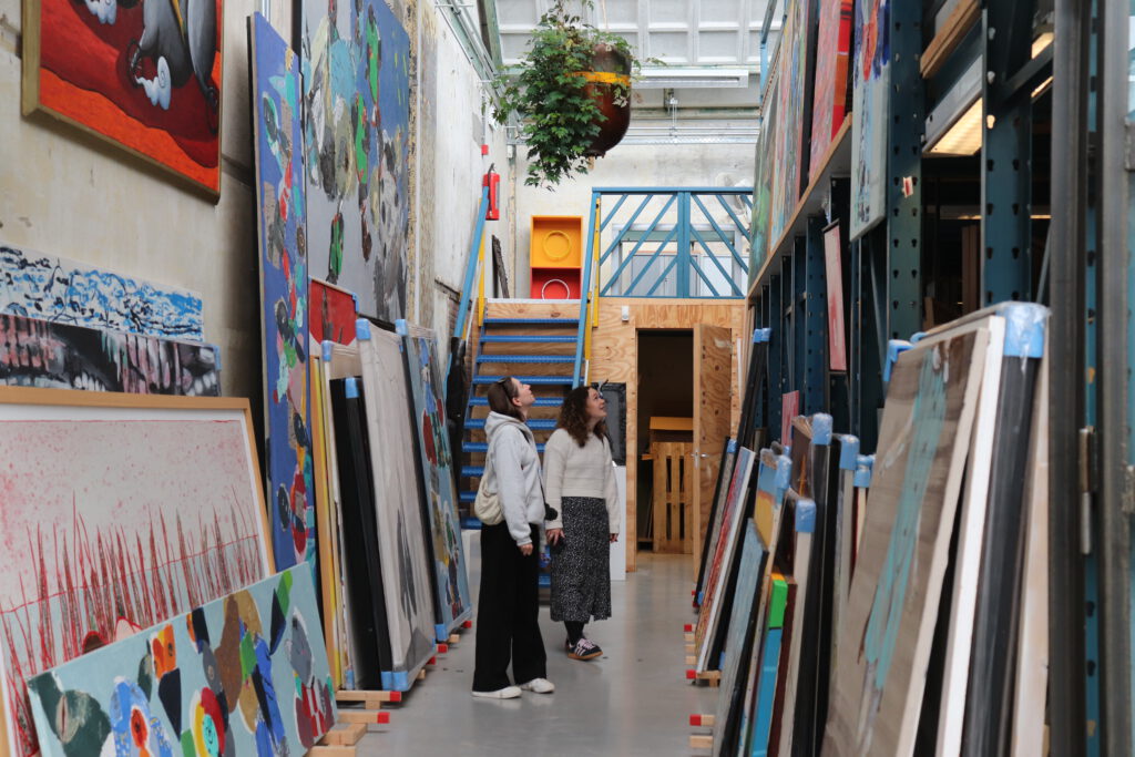 photo-of-two-women-looking-at-art-at-artzaanstad-store-on-hembrug-terrain-near-zaandam