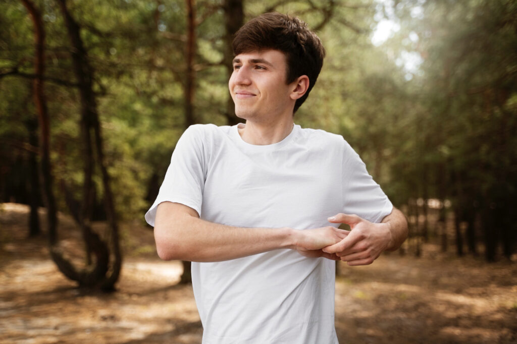 photo-of-man-in-forest-stretching-and-looking-happy