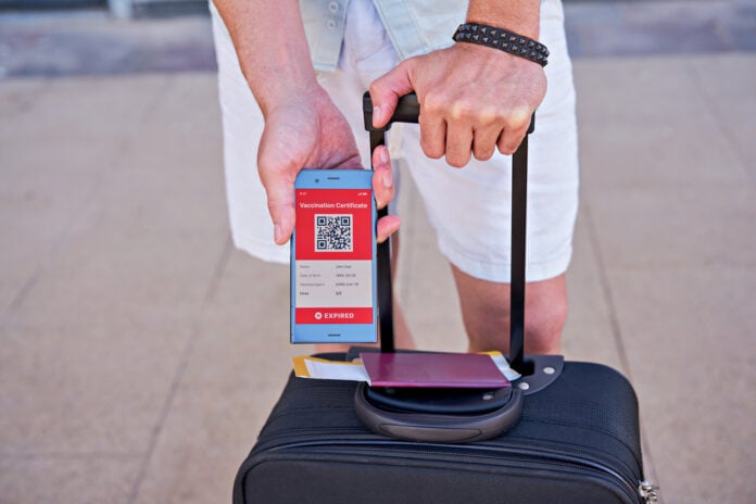 picture-of- person-with-suitcase-and-smartphone-with-vaccination-code