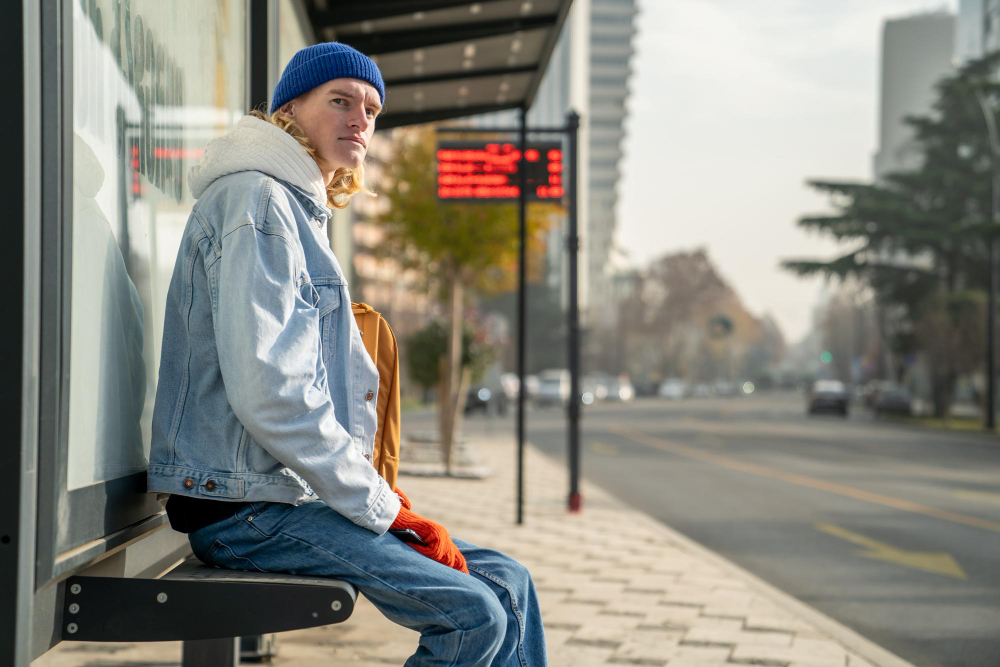 photo-of-man-sitting-at-bus-stop-Netherlands