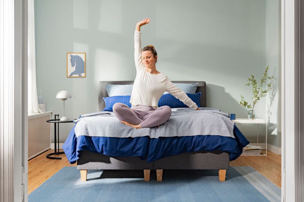 photo-of-woman-stretching-in-comfy-bed-with-cosy-sheets-from-Emma-Sleep