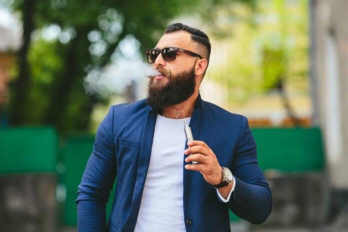 photo-of-well-dressed-man-smoking-vape-in-amsterdam