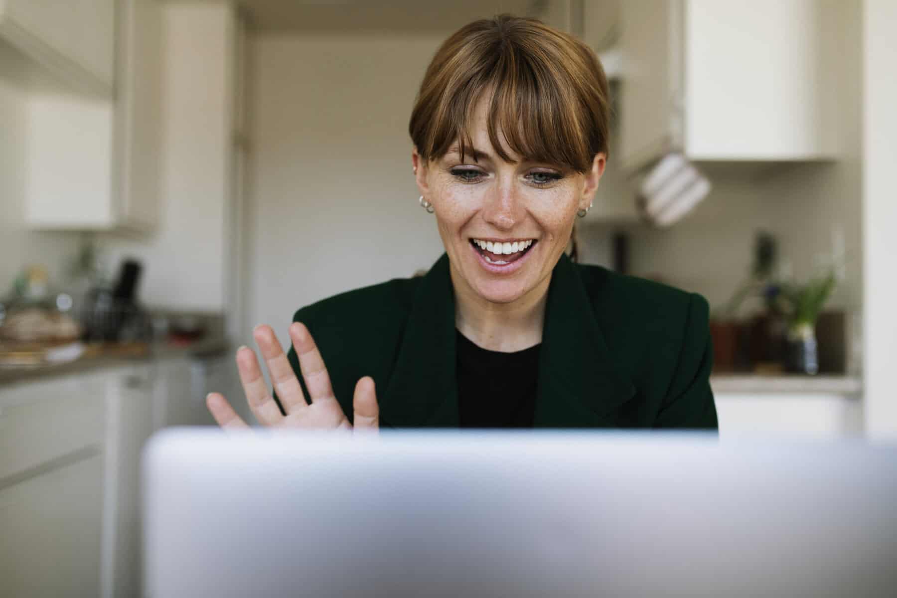 photo-of-woman-on-laptop-attending-welocate-housing-webinar
