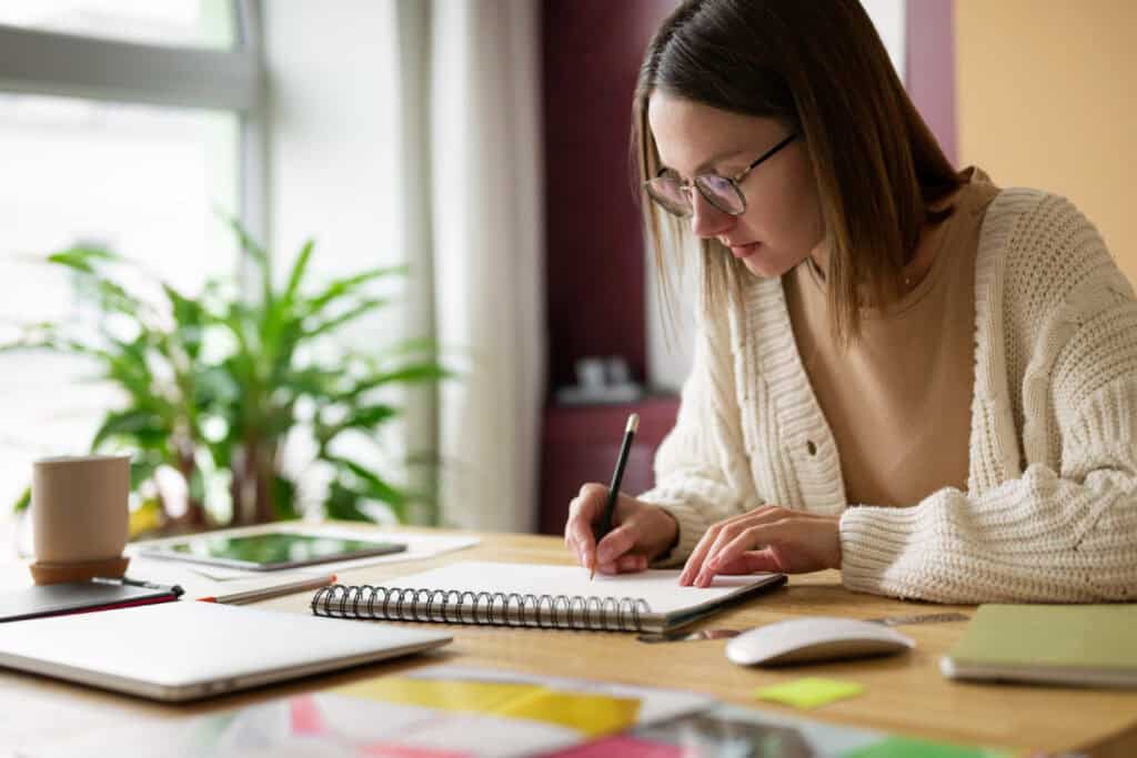 photo-of-woman-sitting-at-desk-studying-for-Dutch-driving-theory-exam