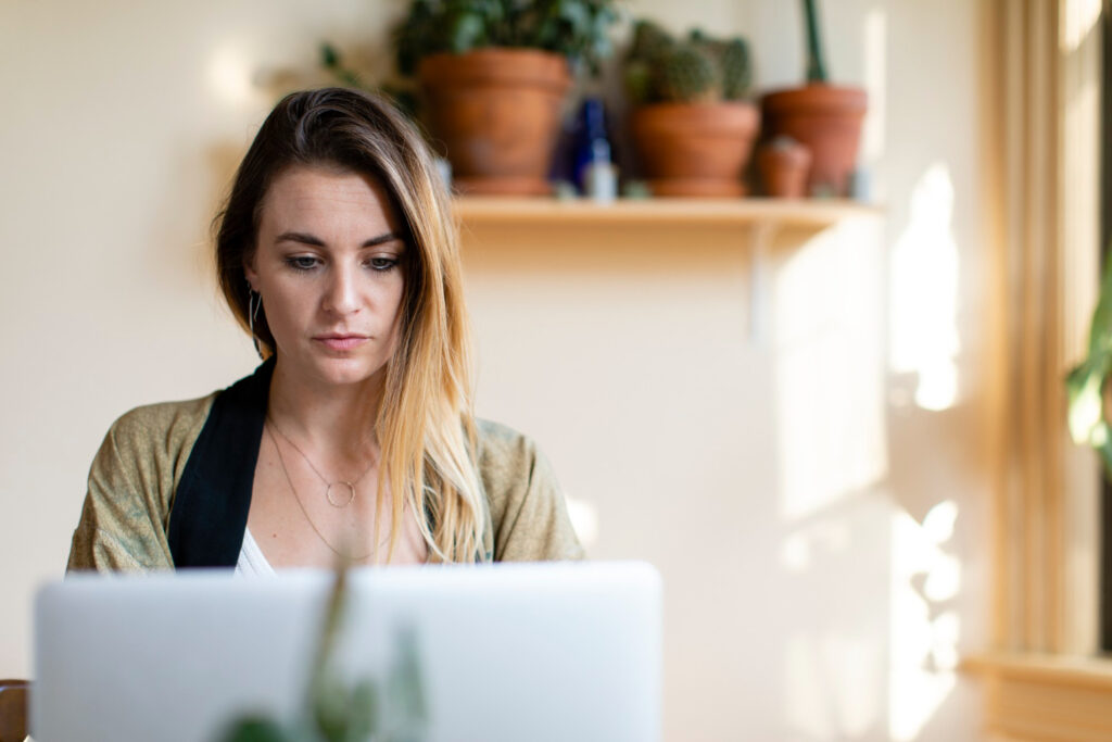 photo-of-woman-looking-at-computer-during-restructuring-process-in-the-netherlands-trying-to-see-what-she-is-entitled-to