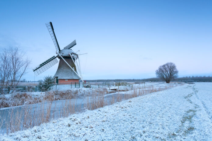 photo-of-frozen-canal-and-windmill-during-freezing-temperatures-Netherlands-with-wind-chill-of-minus-14
