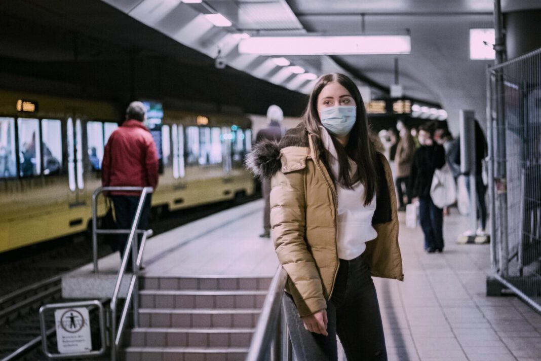 photo-of-a-woman-waiting-for-the-train-coronavirus