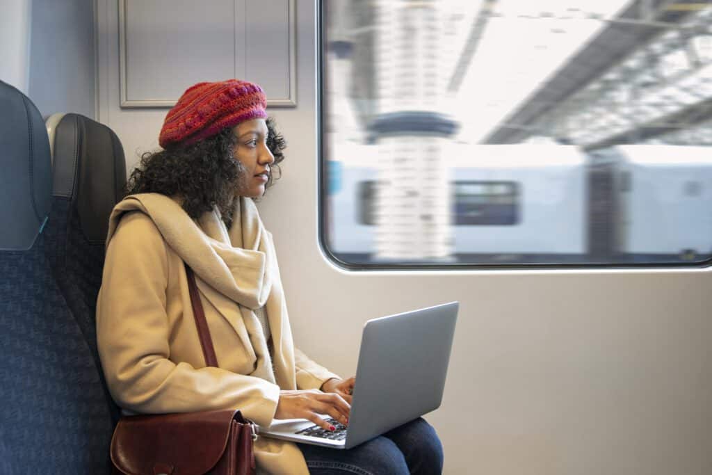 photo-of-woman-holding-laptop-on-train-in-the-netherlands