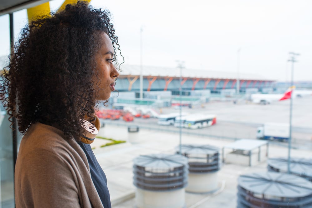 photo-woman-looking-out-the-window-at-airport